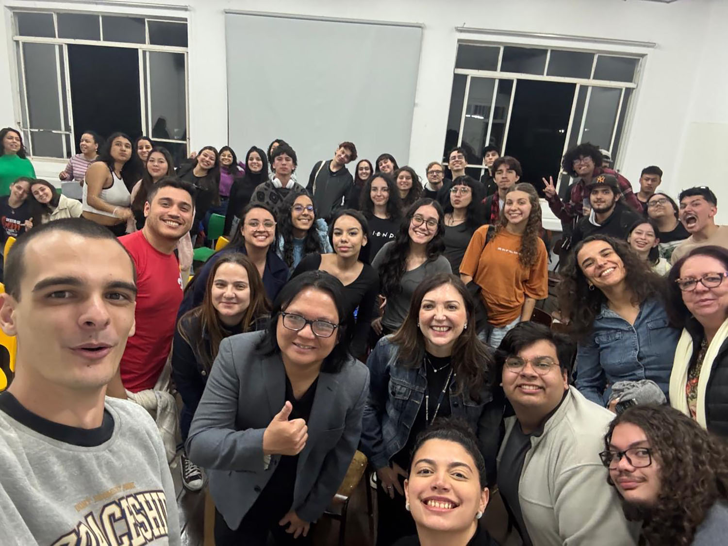 Dr. Augusto Macalalag in the middle of a group of students.