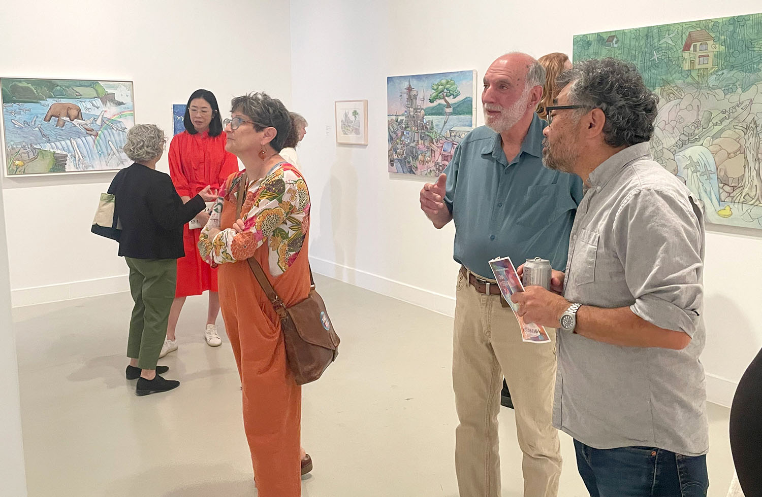 Attendees looking at Hiro Sakaguchi's artwork at the opening reception.