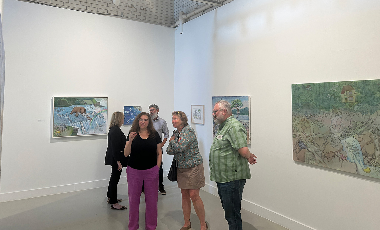 Faculty and staff discussing Sakaguchi's artwork in the Spruance Gallery.