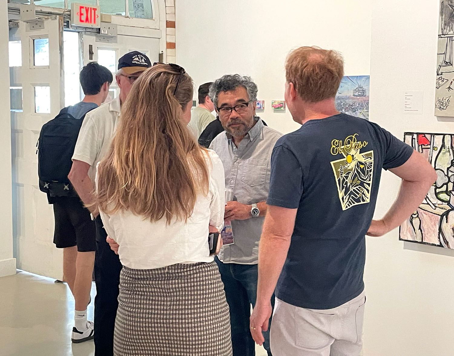 Attendees speaking with Hiro Sakaguchi at the opening reception.