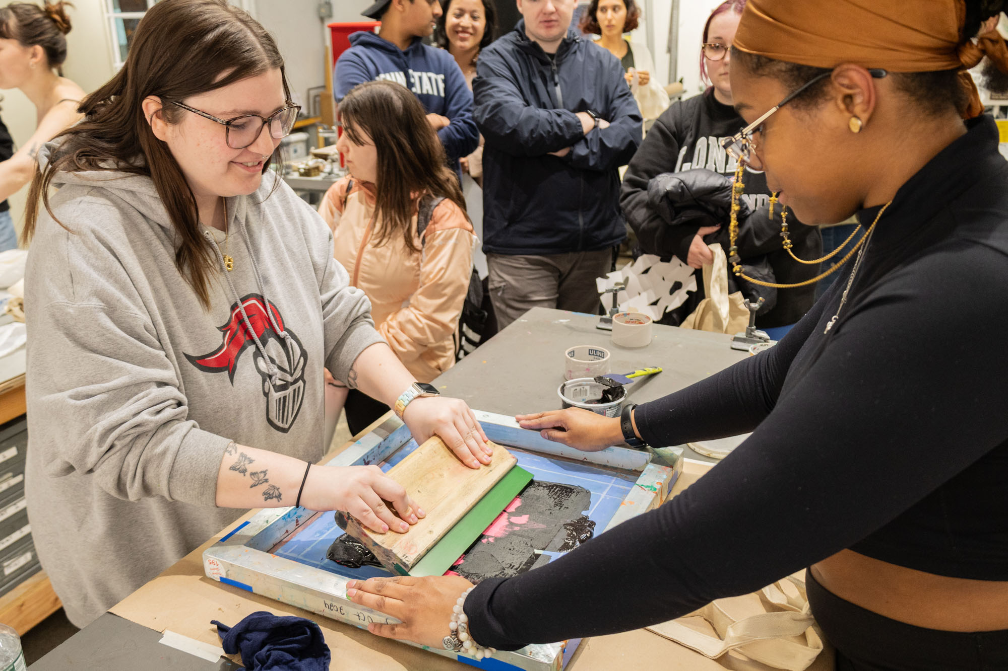 Participants taking part in a screen printing workshop lead by arcadia students