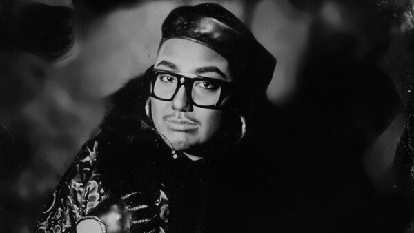 Person in black in white photo wit glasses and a leather hat. For Maurene Cooper "Blue Angels".