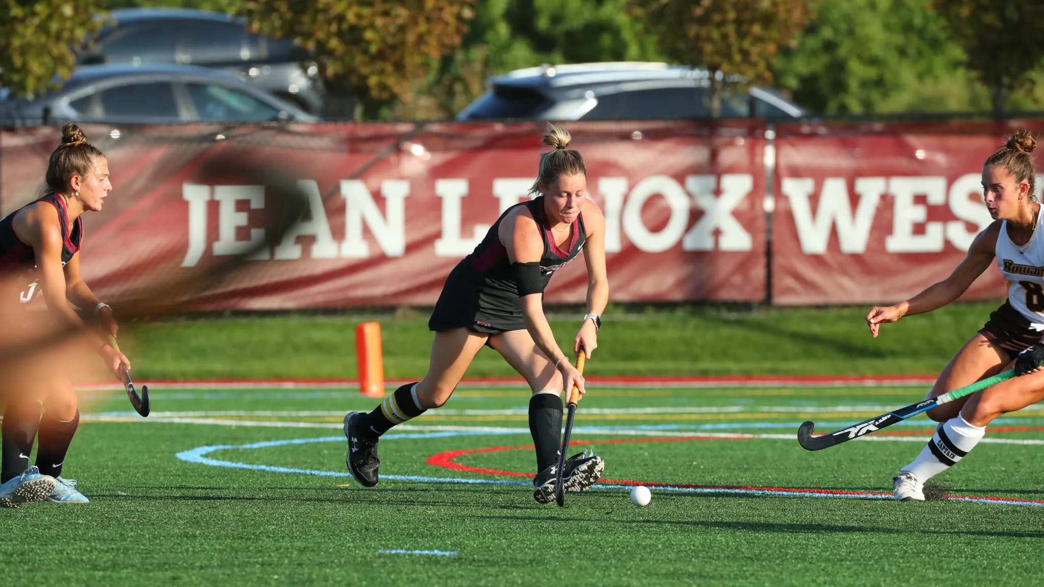Regan playing field hockey as a student athlete on the field hockey team.