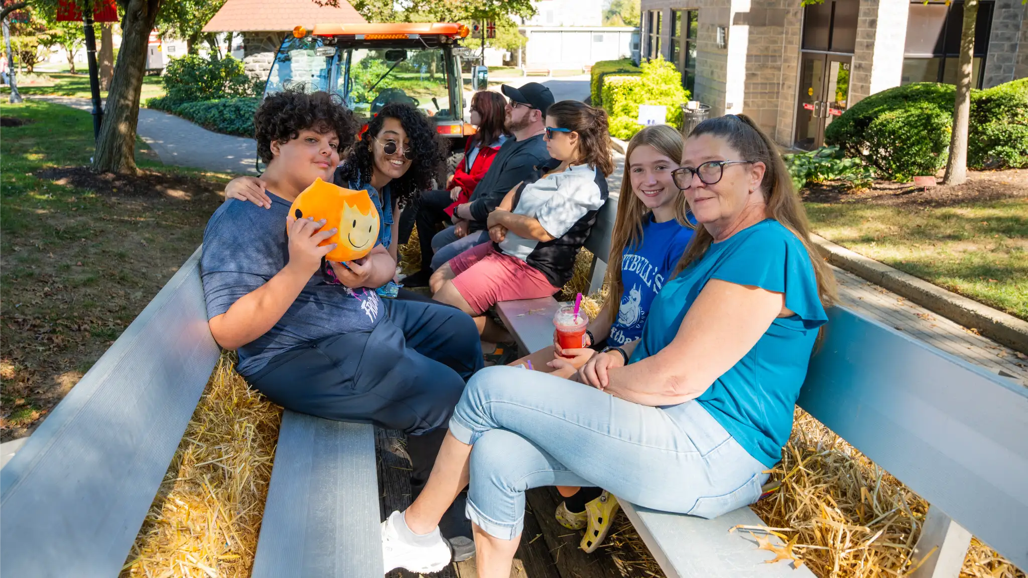 Families sit on benches on the Arcadia campus during Arcadiafest.