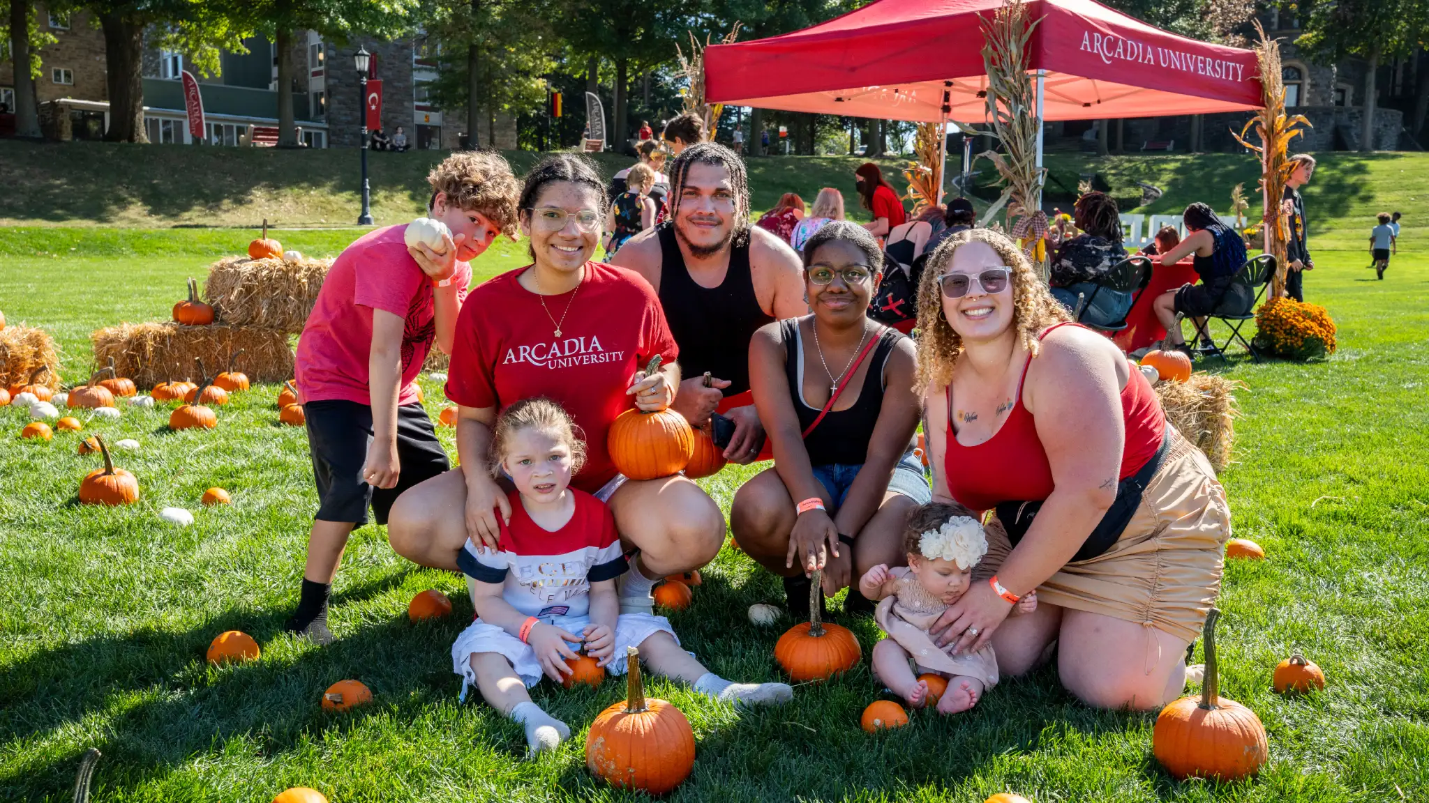 Family and friends pose for a photo in the pumpkin patch on the Haber Green at Arcadiafest.