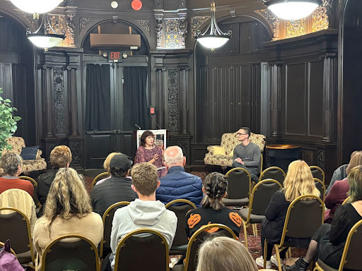 Tracey Levine and Daniel Schall, both sitting in front of an audience, talk about Levine's new collection of short stories.