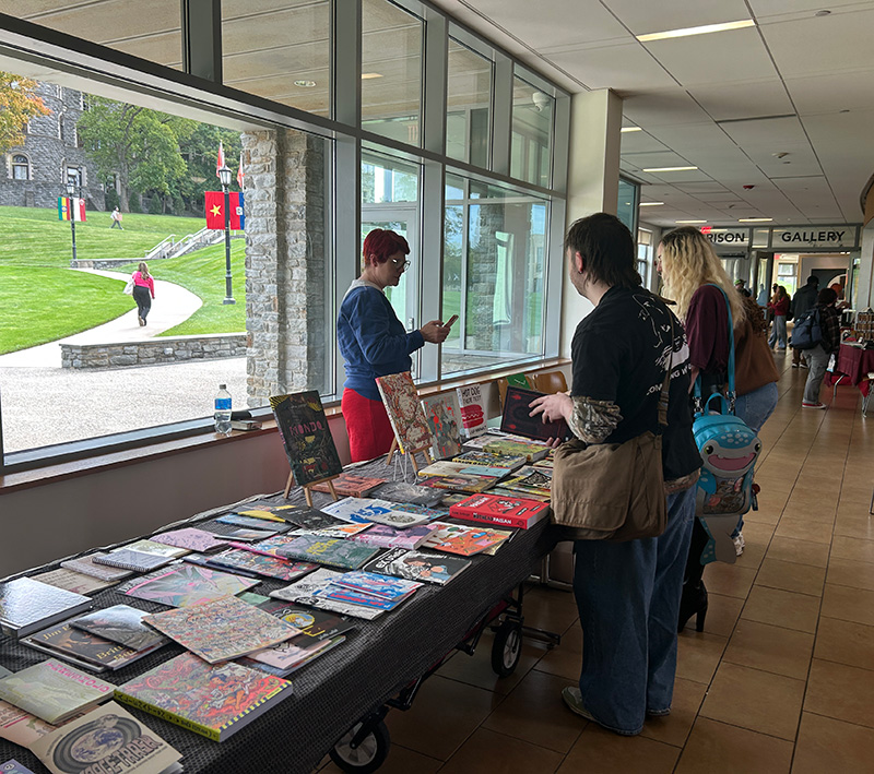 A table set up in the University Commons where a student is selling their self-published zines.