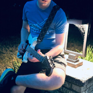 Bird Parry ’29 playing guitar.