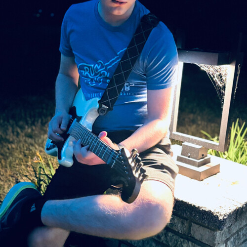 Bird Parry ’29 playing guitar.