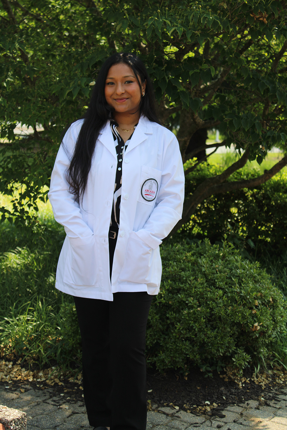 Jenisha Khadka ’27MMS in a PA white coat.
