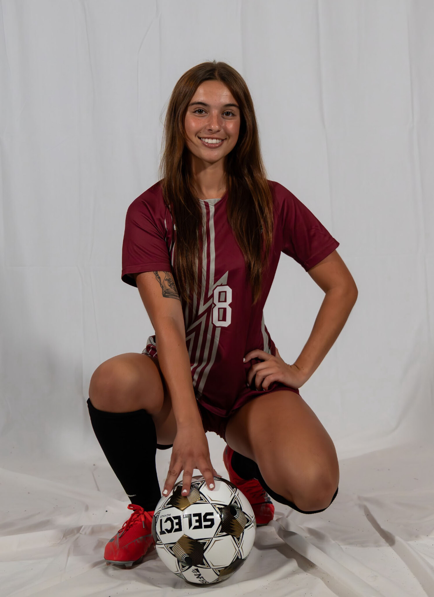 Abby Stephens ’26 in a soccer uniform with a soccer ball.