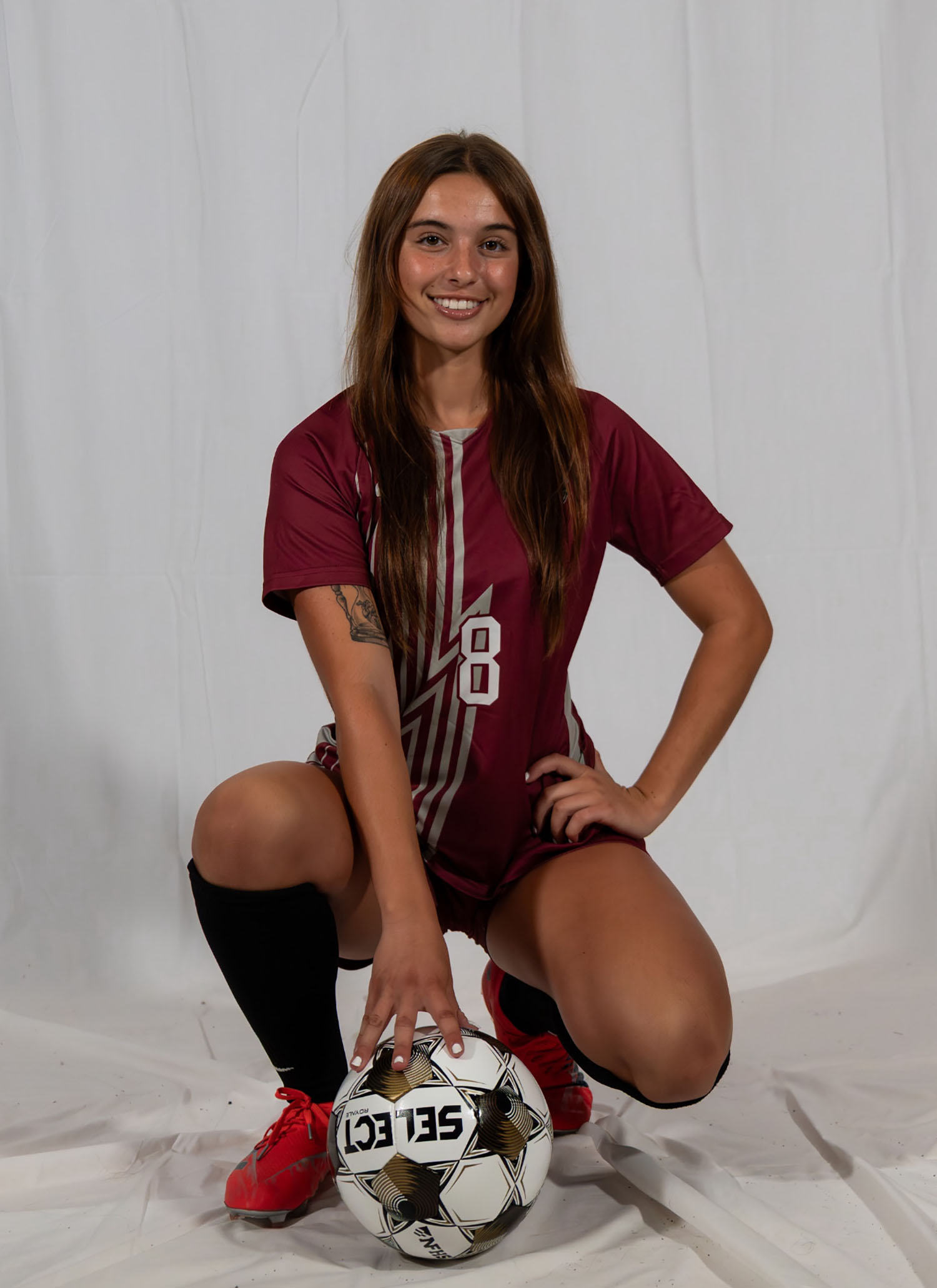 Abby Stephens ’26 in a soccer uniform with a soccer ball.