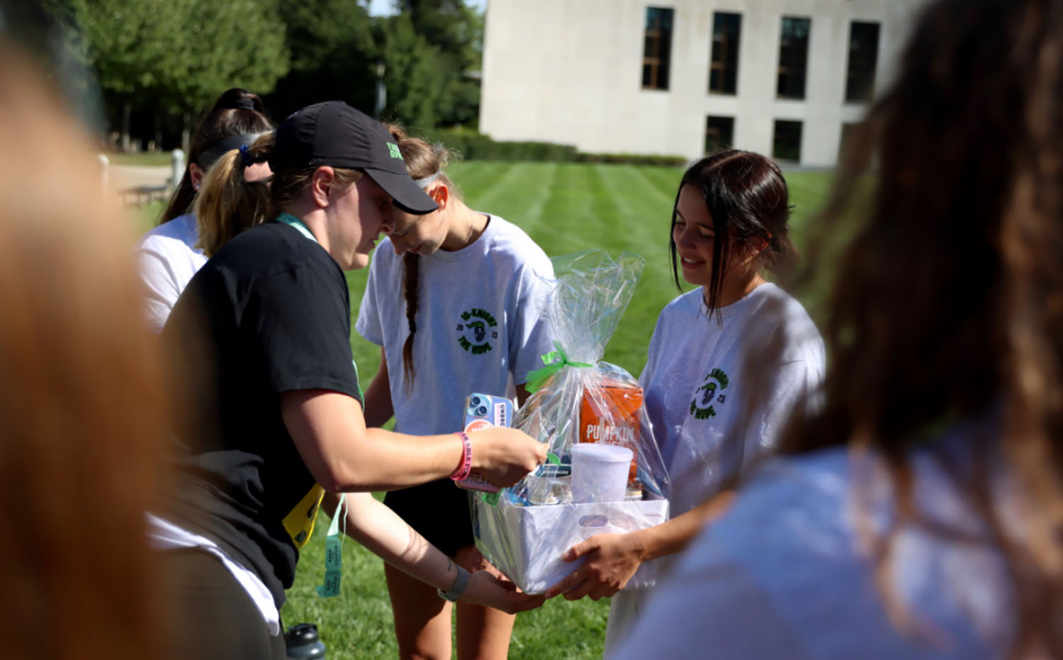 Abby Stephens ’26 handing a basket to someone.