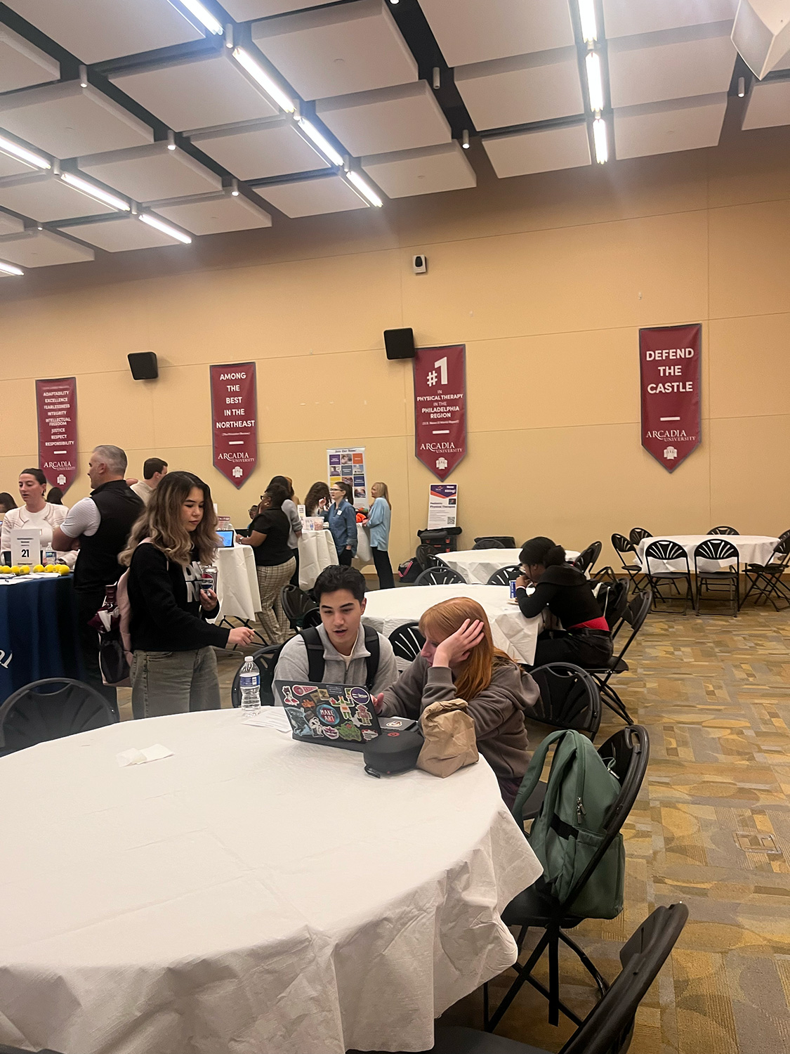 Students sitting at a table talking during Career Fest.