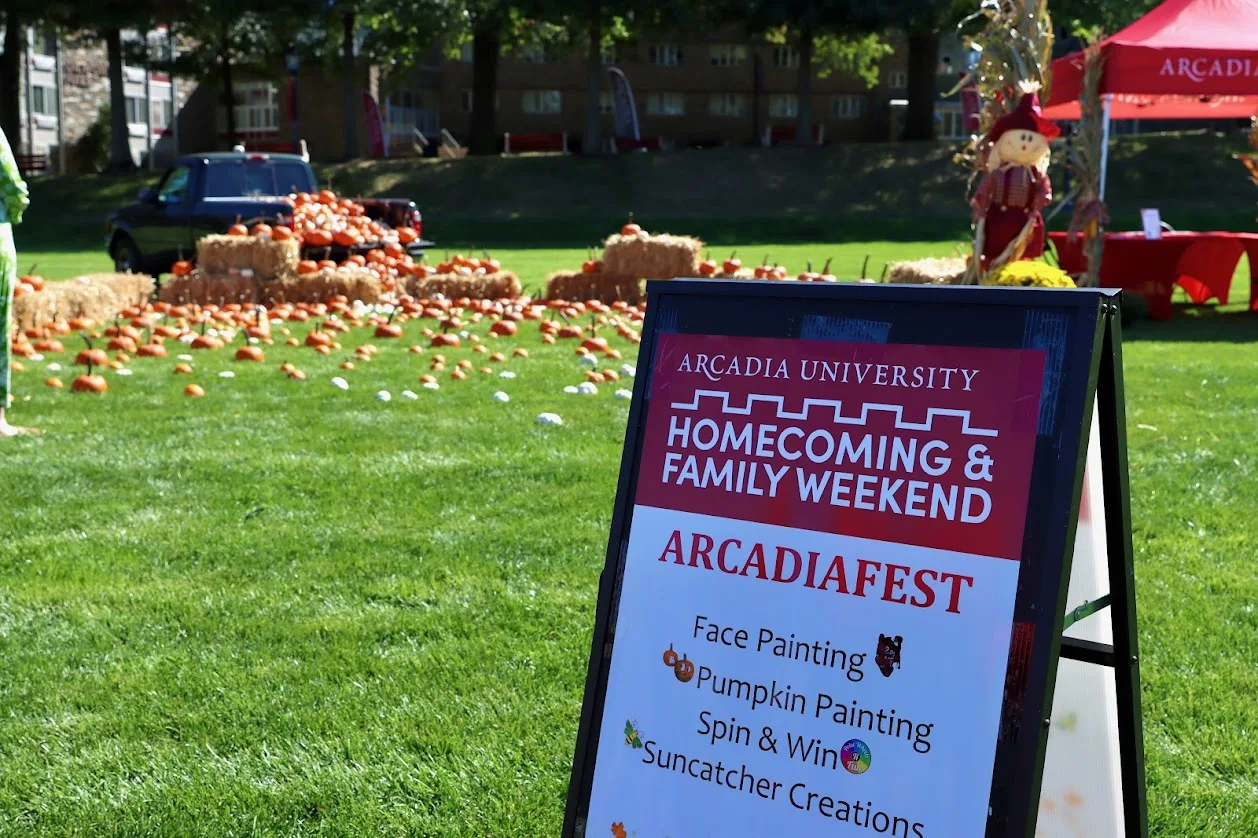 Homecoming and Family Weekend sign announcing activities such as: pumpkin patch, face painting, spin and win, and suncatcher creations.