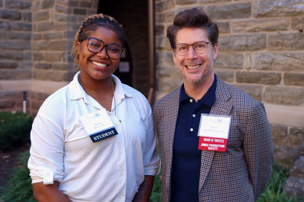 Young, woman student posing with her male scholarship donor. Both are smiling.