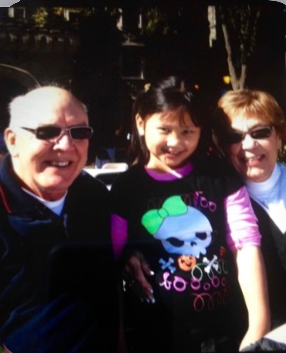 A young Kieran McNulty ’28 (middle) with her grandparents on Arcadia's campus.