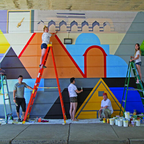 From 2017: Member of the Arcadia community paint a mural on the Easton Road SEPTA overpass.