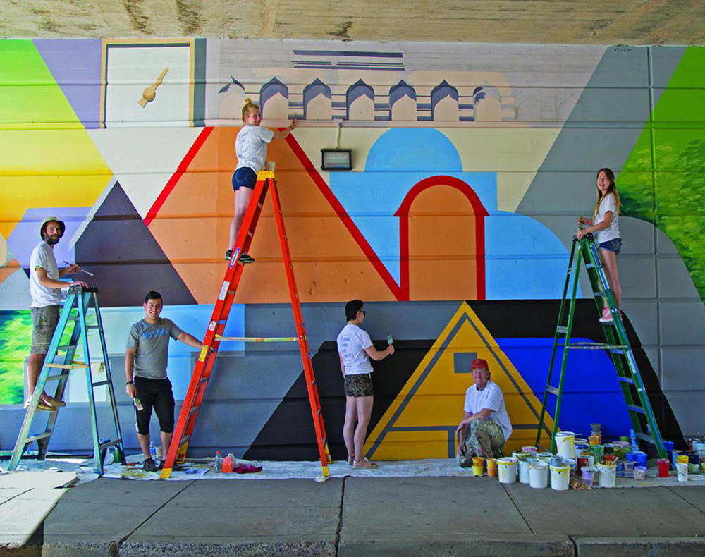 From 2017: Member of the Arcadia community paint a mural on the Easton Road SEPTA overpass.