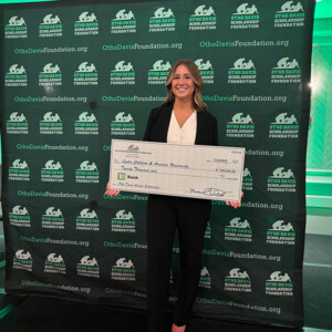 Lydia Collison ’26DPT holds a scholarship check she received for winning the Otho Davis Scholarship