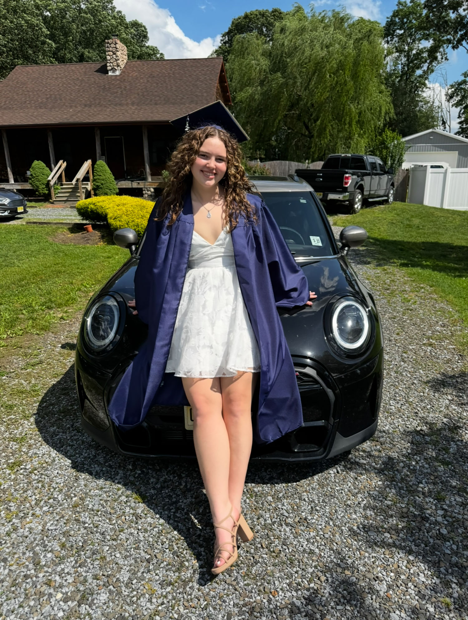 Alexa Casares ’29 sitting on a car.