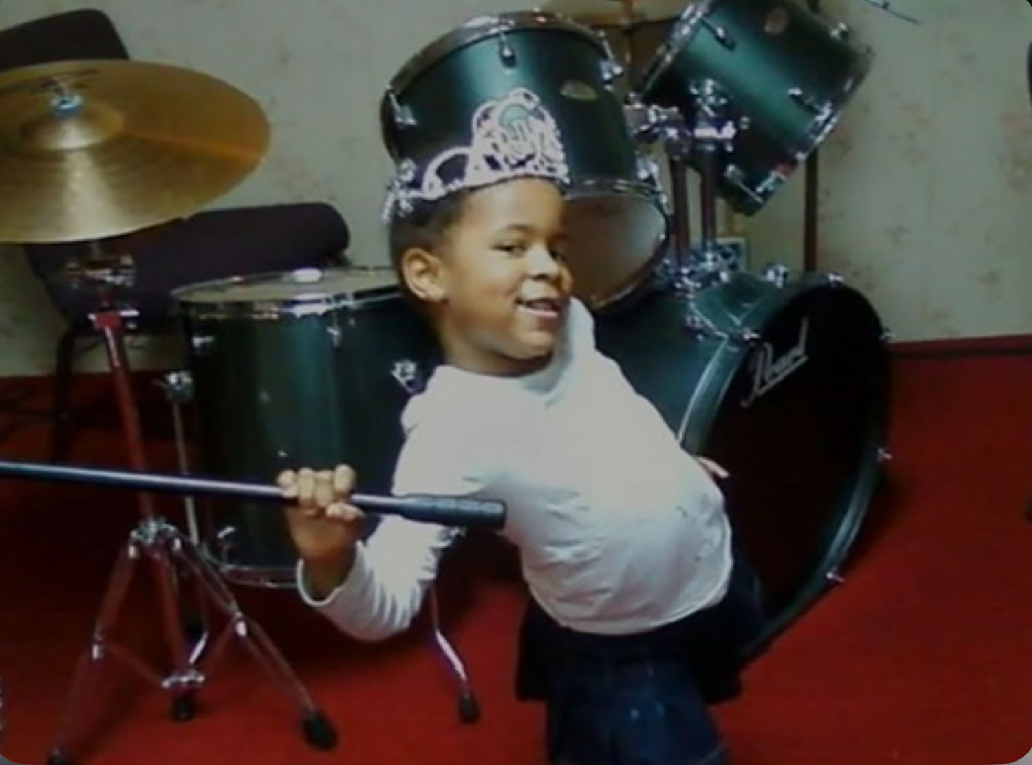 Nydia Clark ’29 as a child with a drumset.