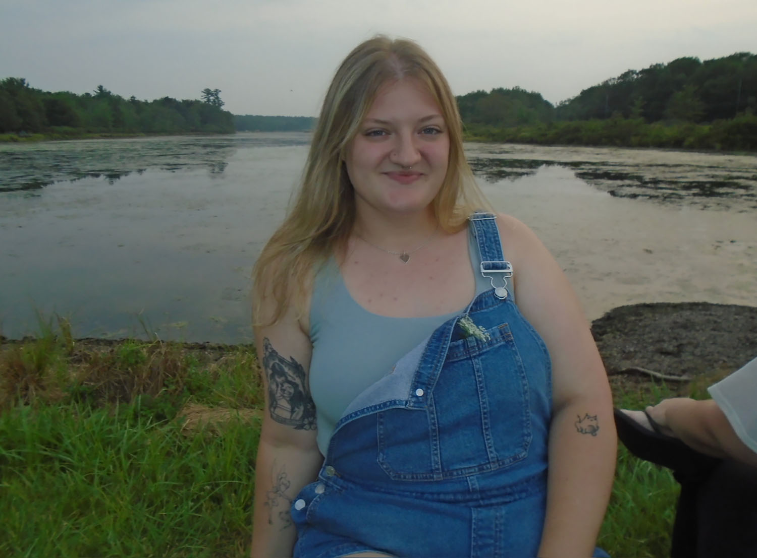 Emily Rooney ’29 standing in front of a lake.
