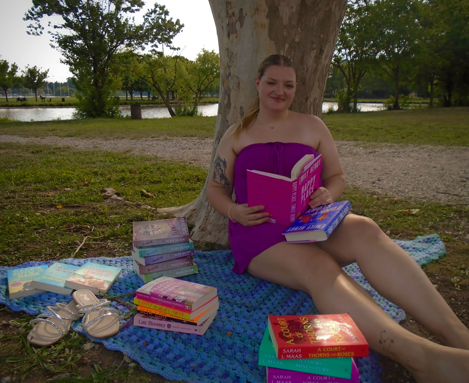 Emily Rooney ’29 reading by a pond.