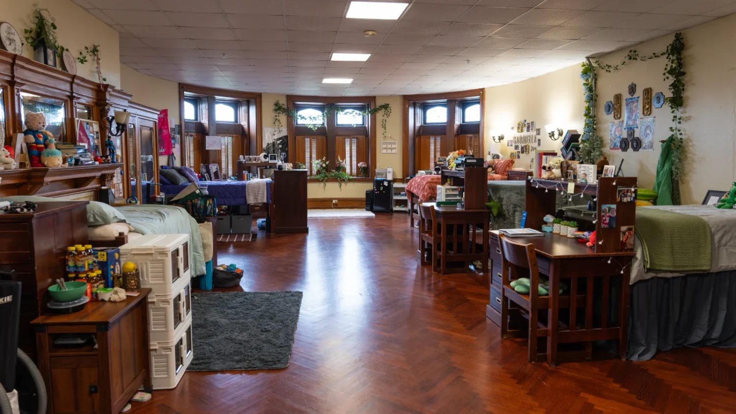 A look in one of the rooms at Grey Towers Castle, where 6 beds are positioned throughout the room on opposite walls.