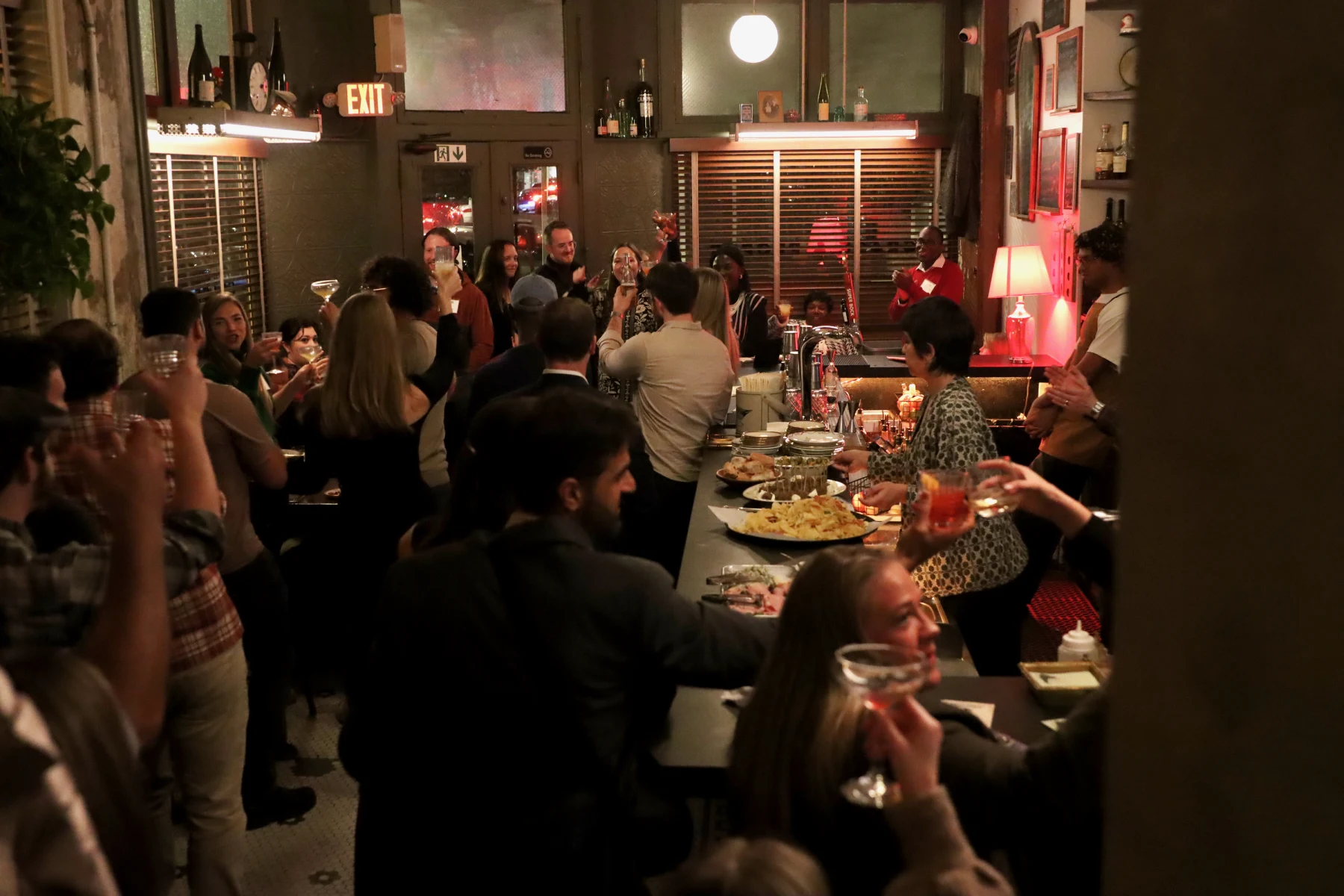 40 under 40 honorees at Arcadia celebrate at a bar.