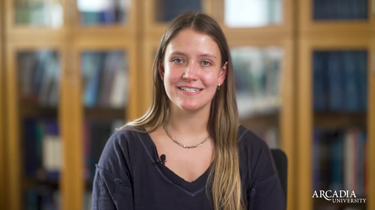 Melissa Behrer smiles and speaks to the camera.