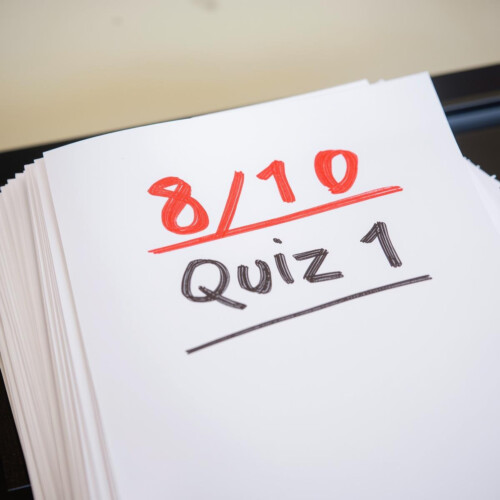 A sheet of paper reading "8/10 Quiz 1"