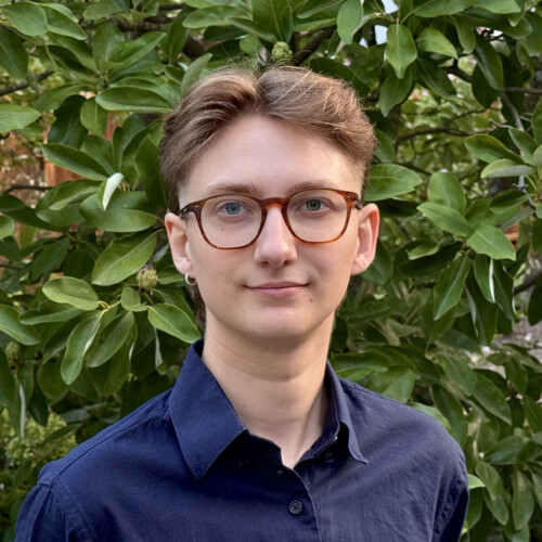 Alexander Given ’27M with leaves in the background.