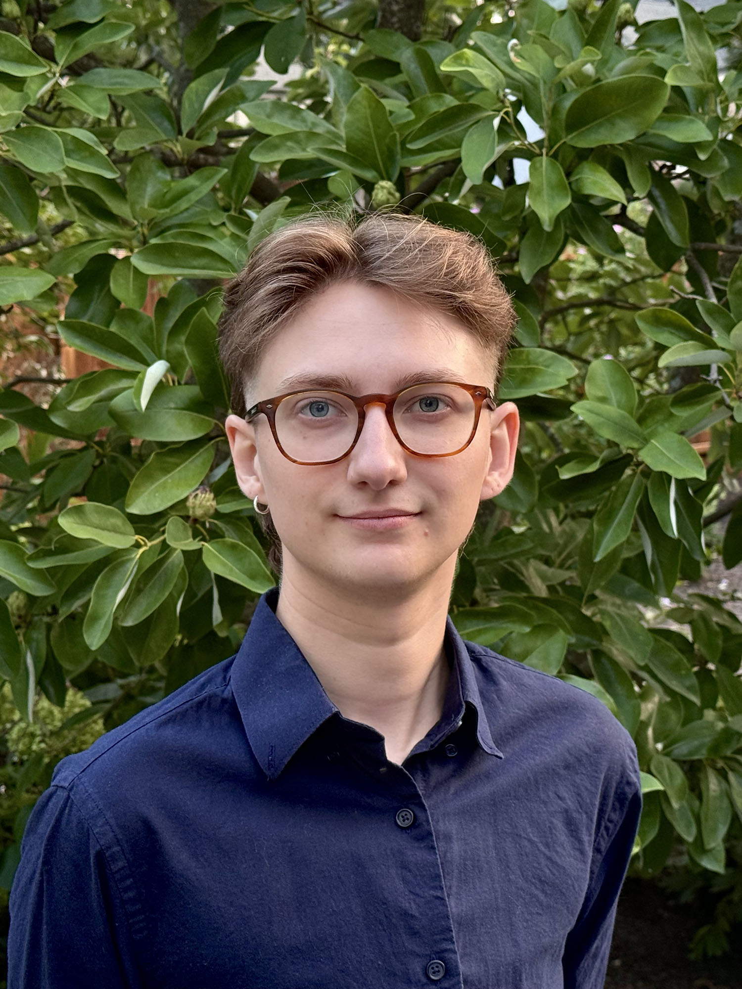 Alexander Given ’27M with leaves in the background.