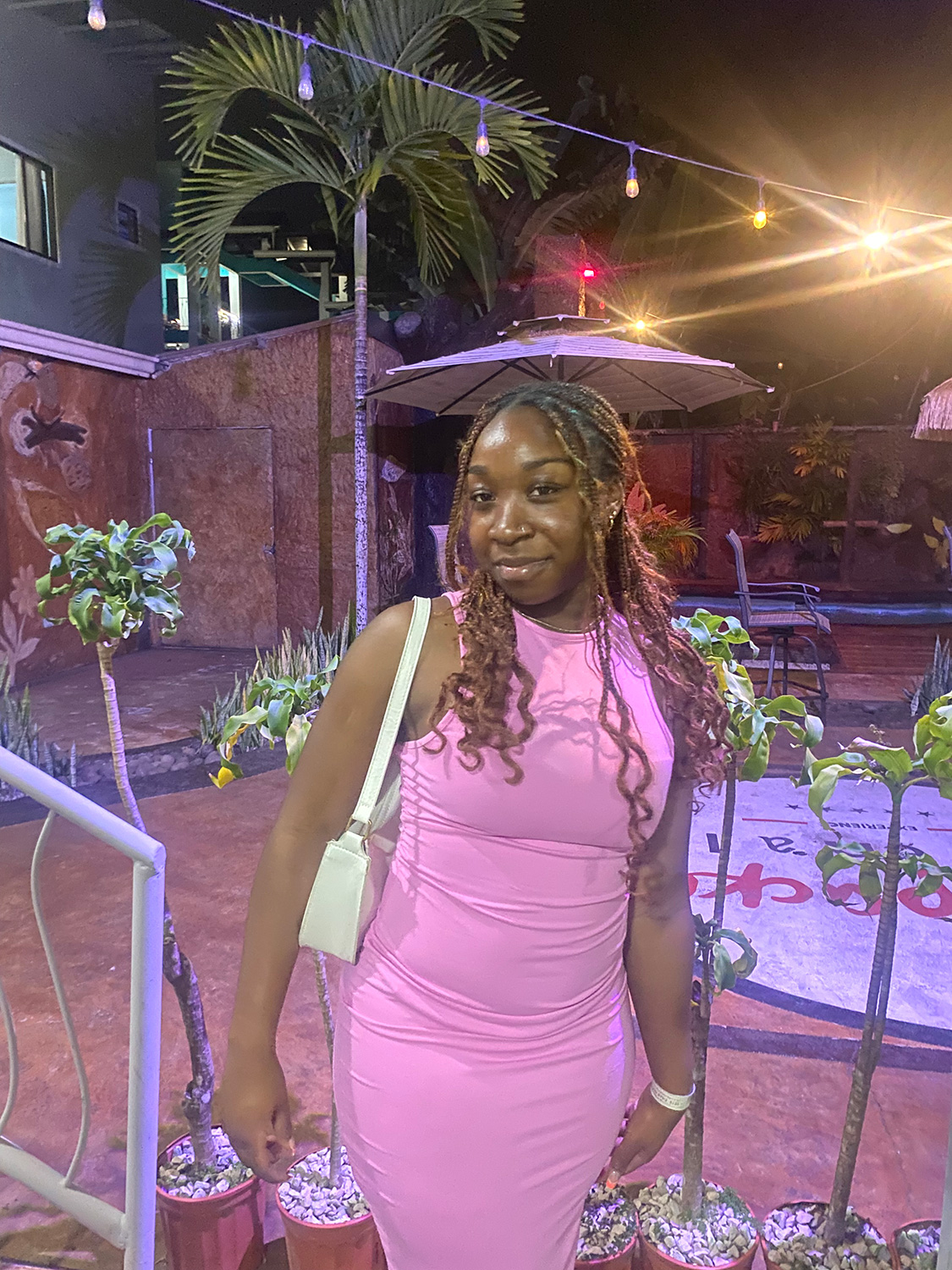 Azariah Giddings ’27 standing in front of a palm tree.