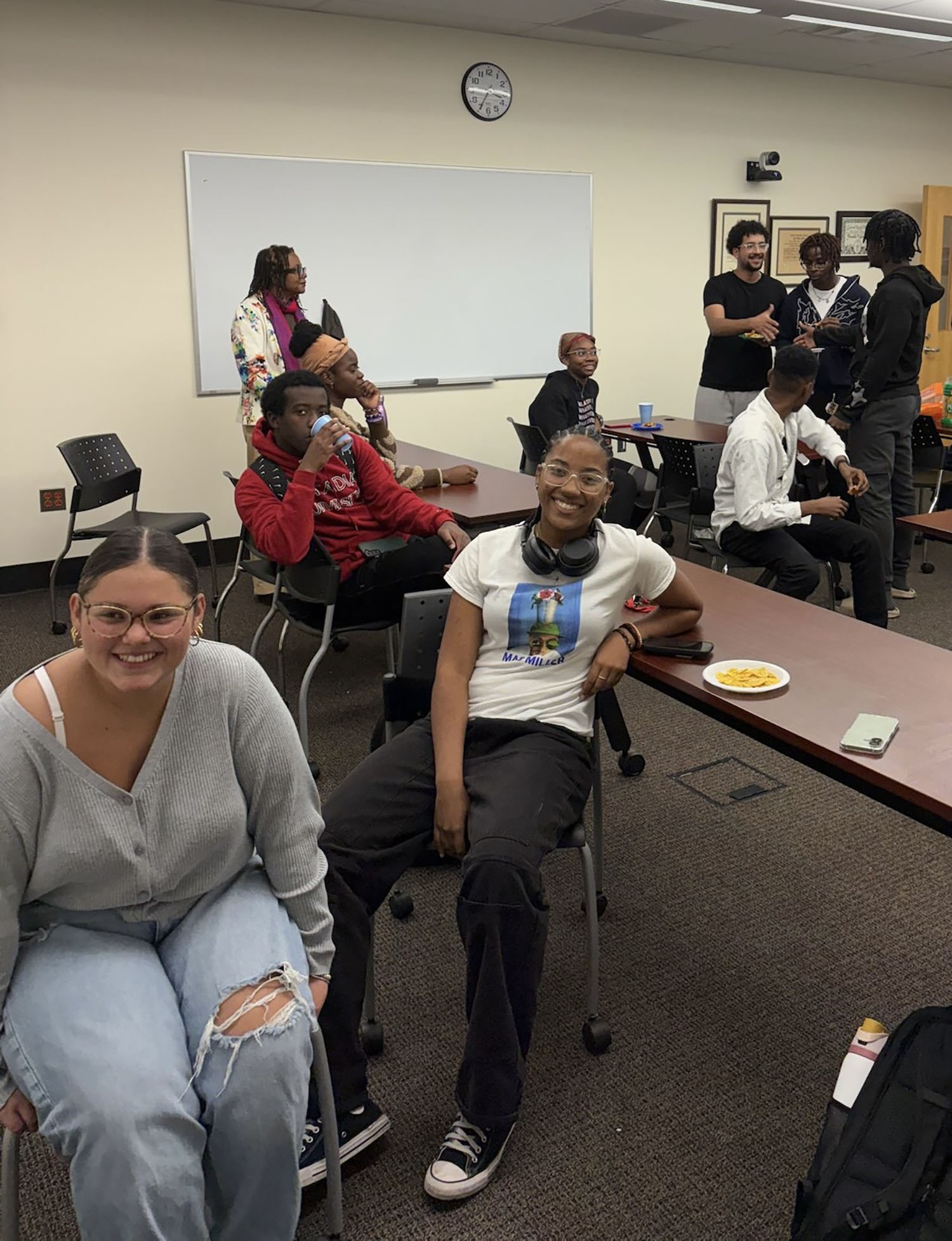 Students laughing together at a Caribbean Students Association meeting.