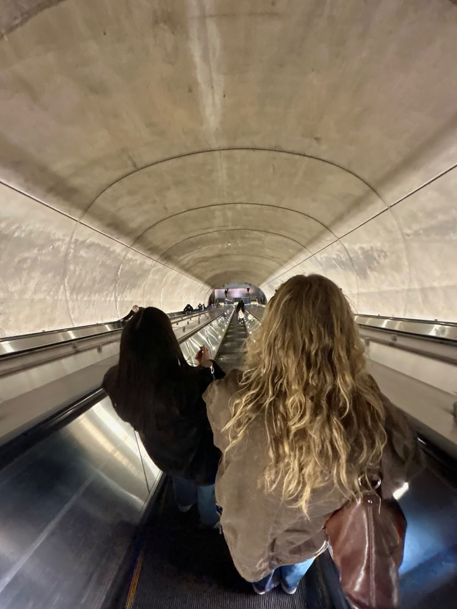 Lily Roberti ’28 on an escalator in a tunnel.