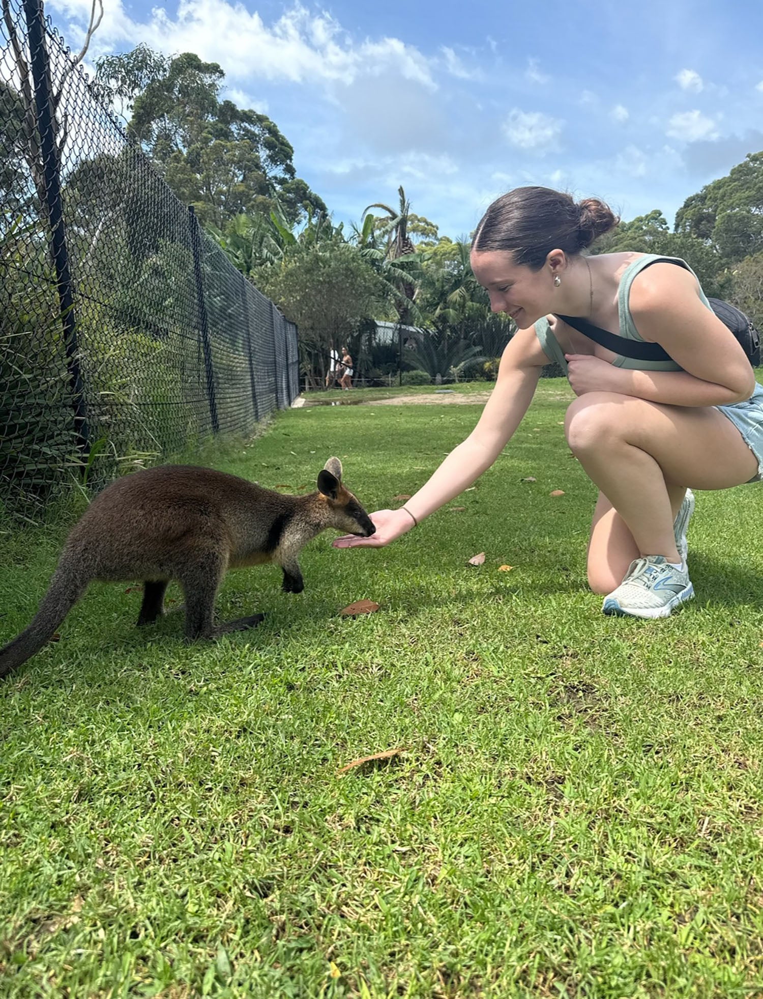 Callie Falzone ’26 feeding a baby kangaroo.