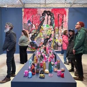 Guests examining the artwork at the exhibition opening.