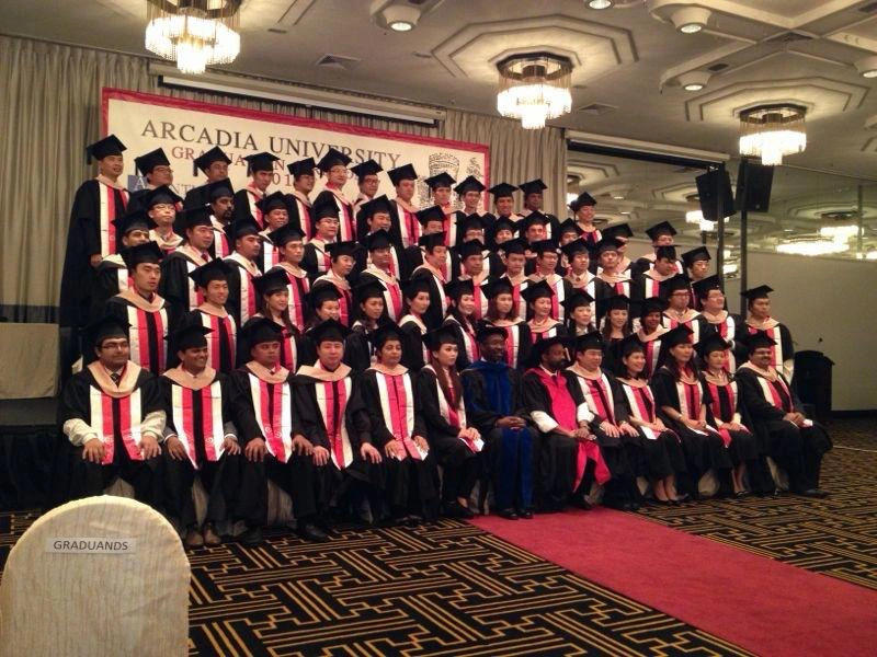 Tan Teck Leng '12MBA poses for a photo with his graduation class on graduation day.