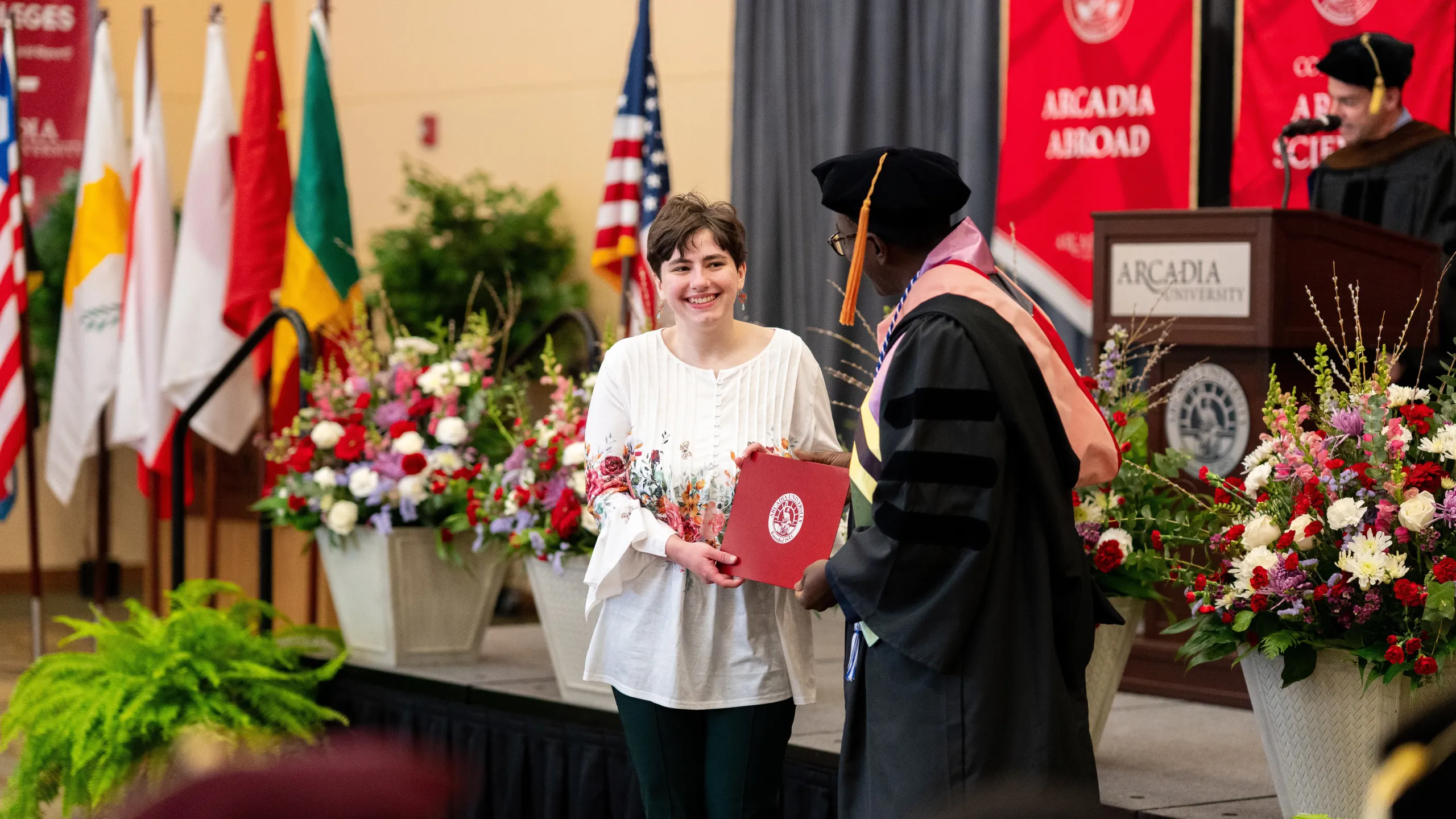 A student accepts an award from Professor Alex O. Otieno at the 2025 Honors Convocation ceremony.