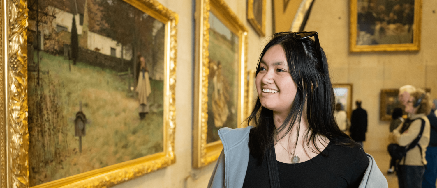 A student observes a framed piece of art in France during their Preview the World trip in 2025.