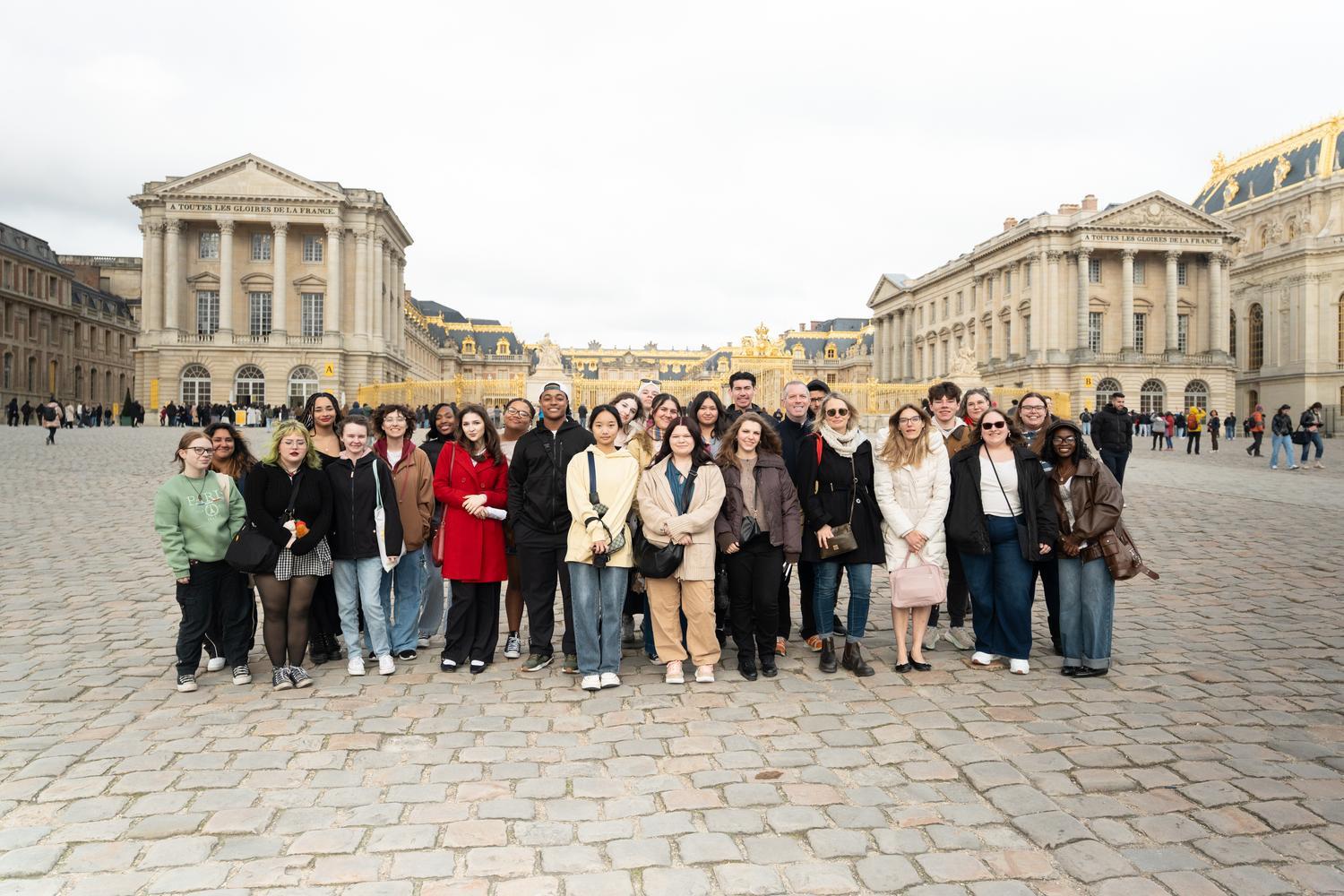 Students standing together outside in Paris, France during their 2025 spring break trip with Preview the World.