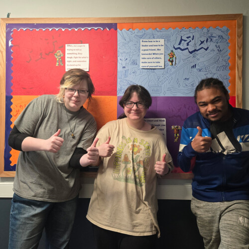 Three students on Corin DeStefano's floor giving a thumbs up.