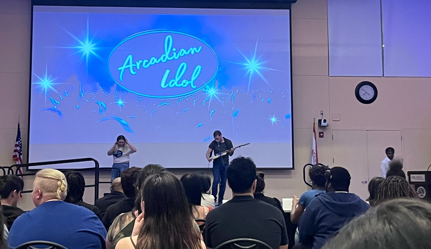 Two student performers on stage at Arcadian Idol 2026.