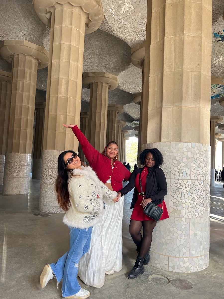 Three sudents pose for a photo at Park Güell in Barcelona, Spain