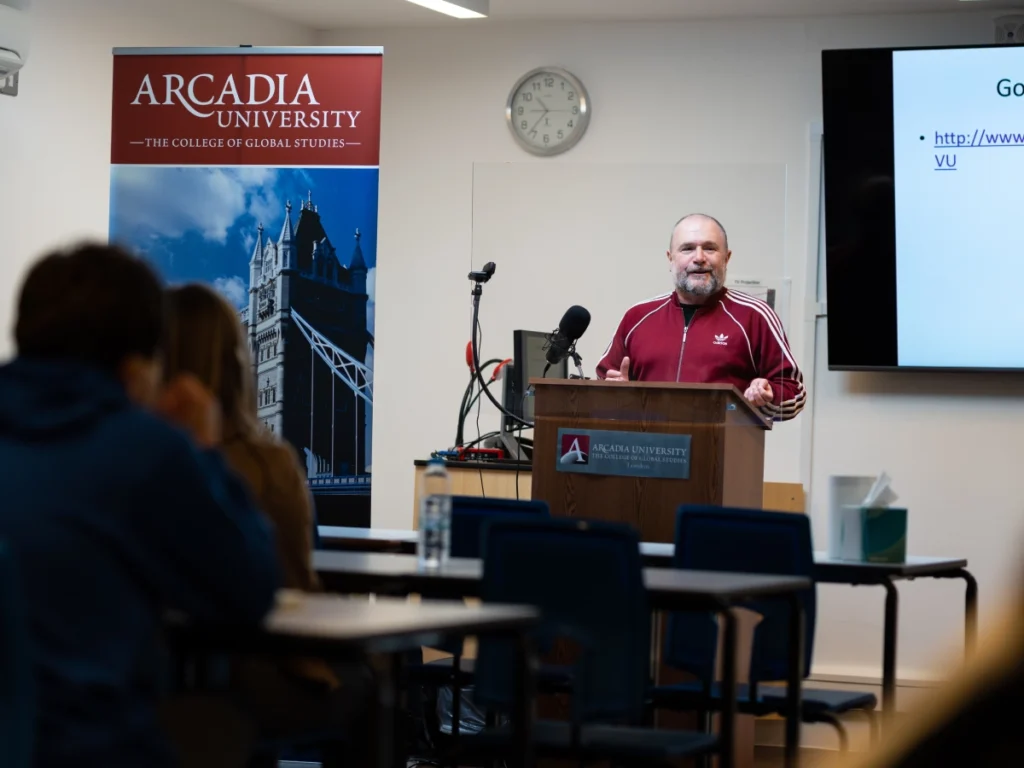 An Arcadia professor gives a lecture in a classroom about London for the London Preview experience.