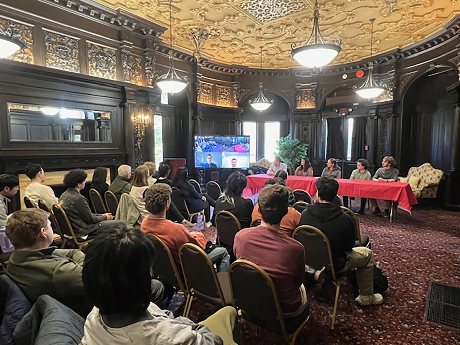 Attendees listening to a panel of STEM students speak.