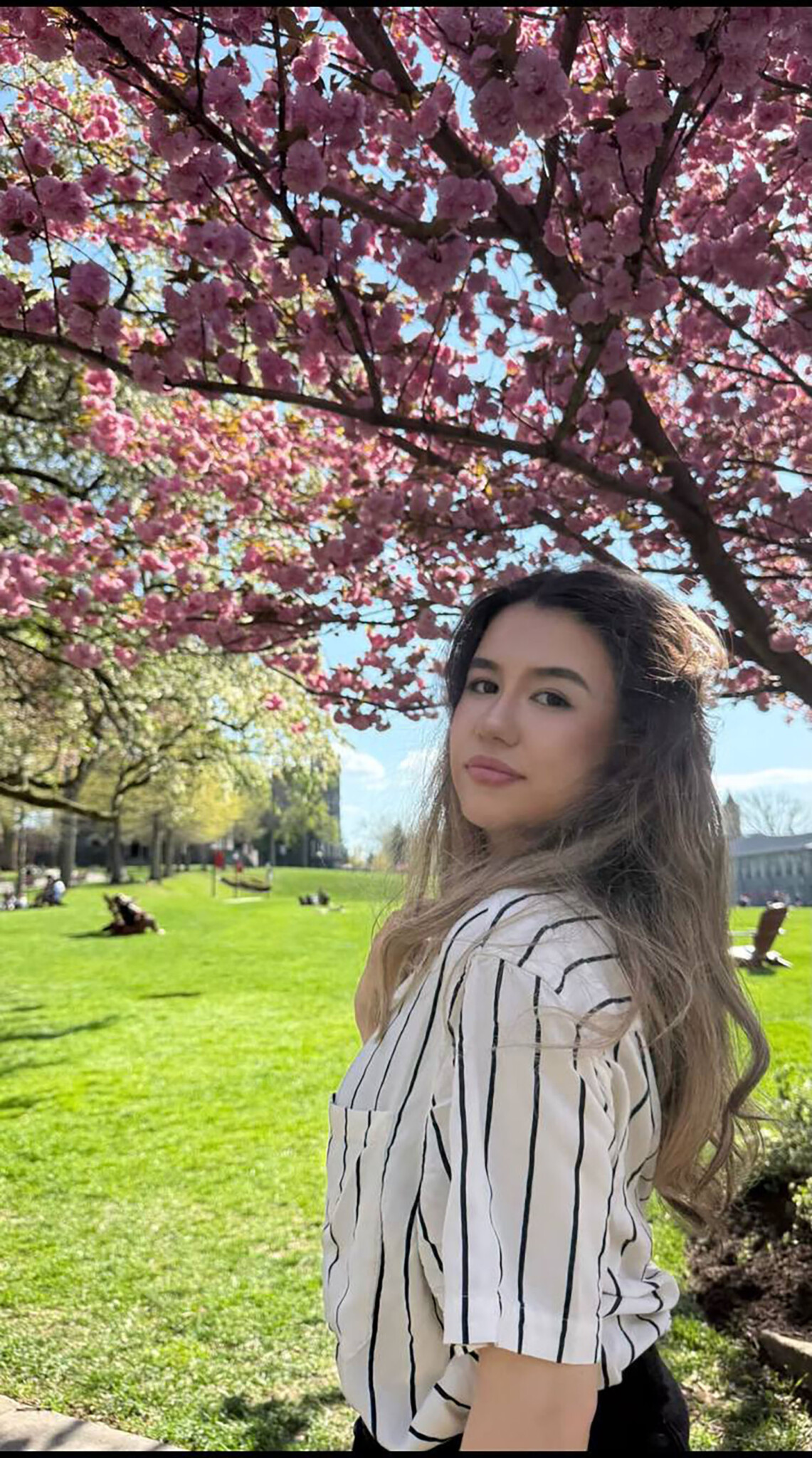 Ameliia Tyncherova ’26 under a flowering tree on Haber Green.