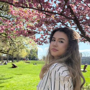 Ameliia Tyncherova ’26 under a flowering tree on Haber Green.